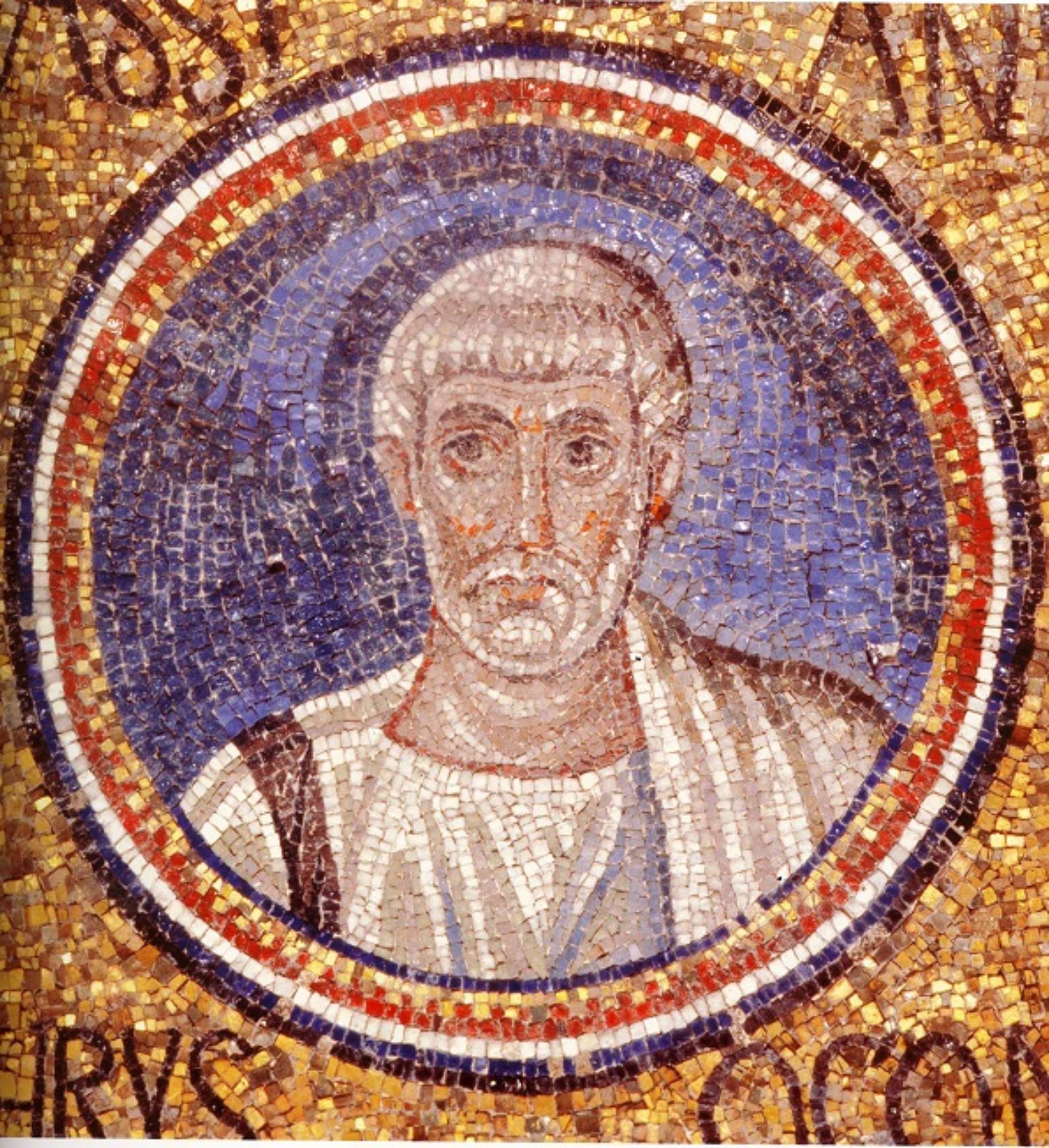 Medaglione in mosaico con busto di S. Cassiano (Ravenna, Cappella Arcivescovile).
Mosaic medallion with bust of St. Cassianus. (Ravenna, Cappella Arcivescovile).

